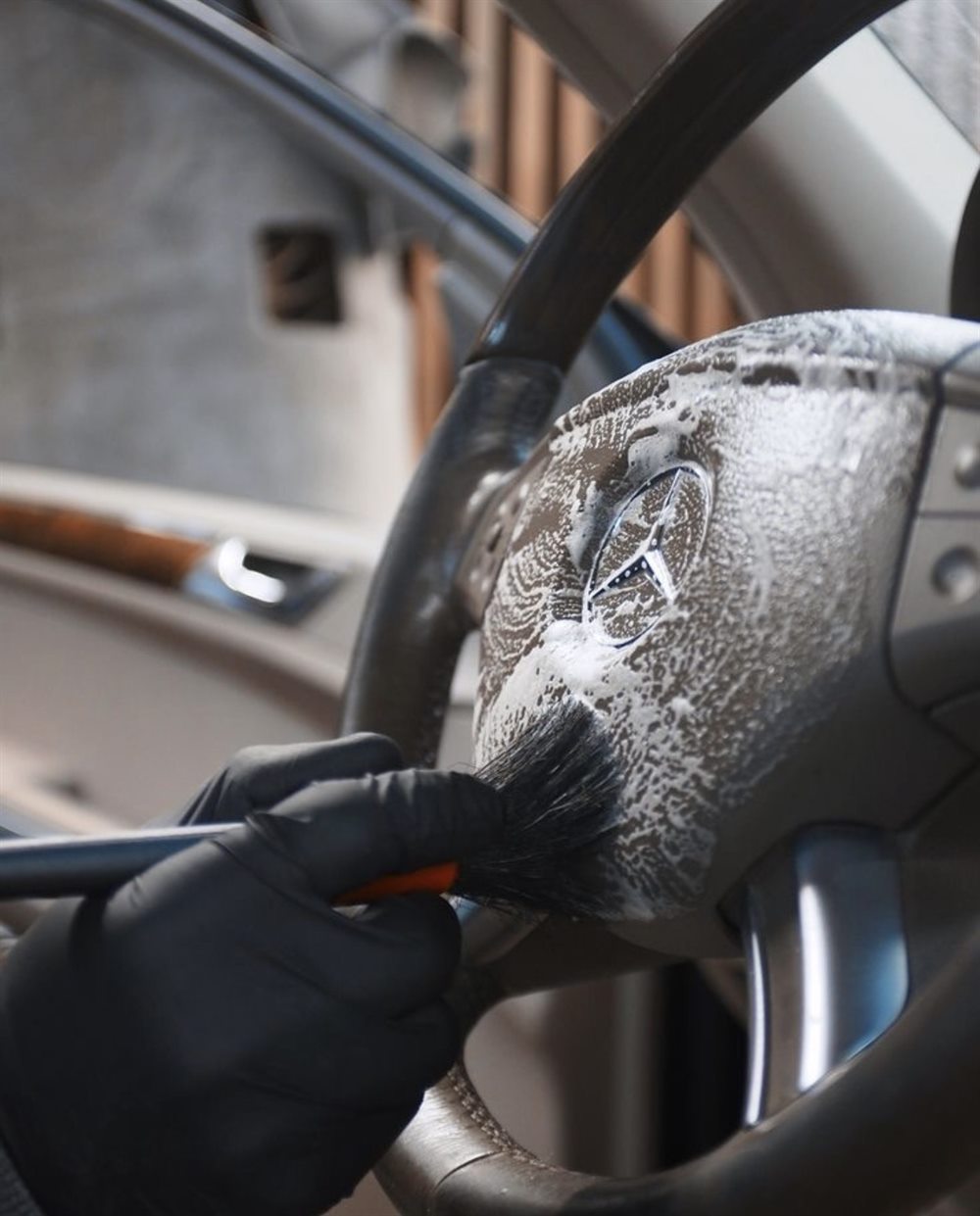 Interior steering wheel cleaning with detailing brush